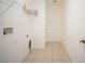 Functional laundry room with tile floors, utility connections, and wire shelving at 11713 Summer Springs Dr, Riverview, FL 33579