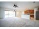 Open-concept living room features tile floors, sliding glass doors, and adjoins the kitchen with stainless steel appliances at 11713 Summer Springs Dr, Riverview, FL 33579