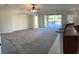 Open-concept living room with access to a private pool and lanai at 11713 Summer Springs Dr, Riverview, FL 33579