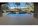 Screened-in pool with surrounding trees and landscaping, perfect for outdoor relaxation at 11713 Summer Springs Dr, Riverview, FL 33579