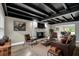 Elegant living room featuring a brick fireplace, leather furniture, black-painted ceiling and stylish decor at 11935 Riverhills Dr, Temple Terrace, FL 33617