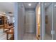 Hallway with white tile flooring, coat closet, and a view into the living room at 12227 Darwood Dr # 0, Hudson, FL 34667