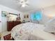 Inviting bedroom with floral bedding, natural light, dresser and mirror, and ceiling fan at 1282 Palm St, Clearwater, FL 33755