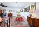 Bright dining room featuring a glass table, wicker chairs, and decorative rugs atop tile floors at 1282 Palm St, Clearwater, FL 33755