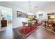 Bright dining room features hardwood floors, chair railing, and walls adorned with beautiful paintings at 1282 Palm St, Clearwater, FL 33755