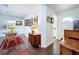 Inviting hallway with wood-look tile floors, artwork, and a dining area at 1282 Palm St, Clearwater, FL 33755