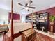 Main bedroom with four poster bed, ceiling fan and built in book shelves at 1282 Palm St, Clearwater, FL 33755