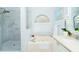 Bright bathroom with tiled shower, marble floor, and bathtub at 18934 Avenue Biarritz, Lutz, FL 33558