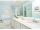 Bright bathroom featuring double sinks and an inset bathtub at 18934 Avenue Biarritz, Lutz, FL 33558