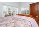 Bright bedroom featuring natural light from the windows and a wooden wardrobe at 18934 Avenue Biarritz, Lutz, FL 33558