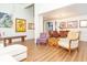 Open-concept living room with high ceilings, wood floors, art and chandelier at 18934 Avenue Biarritz, Lutz, FL 33558