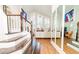 Open living space with high windows, wood floors, staircase, and comfortable seating at 18934 Avenue Biarritz, Lutz, FL 33558
