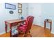 Comfortable office space with a classic desk, red leather chair, and bright natural light at 18934 Avenue Biarritz, Lutz, FL 33558