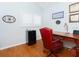 Bright office space with a classic desk, red leather chair, and a view to the outside at 18934 Avenue Biarritz, Lutz, FL 33558