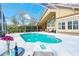 Gorgeous pool with a lounging area, surrounded by lush greenery, and perfect for relaxation at 18934 Avenue Biarritz, Lutz, FL 33558