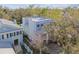 Bird's-eye view of a two-story home with light-colored exterior and blue shutters surrounded by trees at 2508 W Shell Point Rd, Tampa, FL 33611