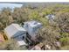 Aerial view of a home nestled among lush trees with a glimpse of the water nearby at 2508 W Shell Point Rd, Tampa, FL 33611