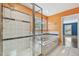 Bathroom featuring a walk-in shower, jacuzzi, and storage at 2508 W Shell Point Rd, Tampa, FL 33611