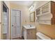 Bathroom featuring vanity, mirror, light fixture, and built-in storage at 2508 W Shell Point Rd, Tampa, FL 33611