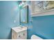 Bathroom featuring vanity, mirror, light fixture and blue walls at 2508 W Shell Point Rd, Tampa, FL 33611