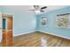 Bedroom featuring wood floors, two windows, and ceiling fan at 2508 W Shell Point Rd, Tampa, FL 33611