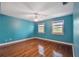 Bright bedroom with hardwood floors, two windows, and a ceiling fan at 2508 W Shell Point Rd, Tampa, FL 33611