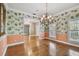 Dining room showcasing hardwood floors, a chandelier, and decorative wallpaper at 2508 W Shell Point Rd, Tampa, FL 33611