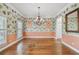 Elegant dining room featuring hardwood floors, a chandelier, and decorative wallpaper at 2508 W Shell Point Rd, Tampa, FL 33611