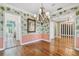 Elegant dining room featuring hardwood floors, chandelier, stylish wall coverings and a large mirror at 2508 W Shell Point Rd, Tampa, FL 33611
