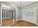 Inviting entryway with double doors, herringbone wood floors, chandelier, and view into striped living room at 2508 W Shell Point Rd, Tampa, FL 33611