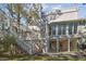 Exterior elevation of the home featuring deck, large windows, and pergola at 2508 W Shell Point Rd, Tampa, FL 33611