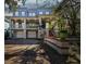 Inviting two-story home featuring a spacious porch, bright blue shutters, and a two-car garage at 2508 W Shell Point Rd, Tampa, FL 33611