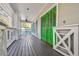Spacious covered front porch featuring a vibrant green double door entrance at 2508 W Shell Point Rd, Tampa, FL 33611