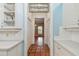 Hallway boasts terracotta tile floors, white cabinets, and a stained glass window above a framed doorway at 2508 W Shell Point Rd, Tampa, FL 33611