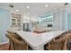 Well-equipped kitchen with terracotta tile floors, a bar and seating, white cabinets and modern appliances at 2508 W Shell Point Rd, Tampa, FL 33611