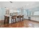 Spacious kitchen with terracotta tile floors, a bar and seating, and crisp white cabinets at 2508 W Shell Point Rd, Tampa, FL 33611