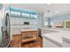 Spacious kitchen with white cabinets, stainless appliances, island with breakfast bar and large clerestory windows at 2508 W Shell Point Rd, Tampa, FL 33611
