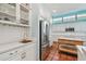 Kitchen boasts stainless appliances, white cabinets, and an island with breakfast bar, illuminated by clerestory windows at 2508 W Shell Point Rd, Tampa, FL 33611