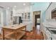 Spacious kitchen with white cabinets, stainless steel appliances, large wood island, and terracotta tile floors at 2508 W Shell Point Rd, Tampa, FL 33611
