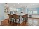 Spacious kitchen with terracotta tile floors, a bar and seating, white cabinets, and modern appliances at 2508 W Shell Point Rd, Tampa, FL 33611