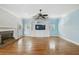 Bright living room with hardwood floors, a decorative fireplace, and built in shelving at 2508 W Shell Point Rd, Tampa, FL 33611
