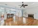 Open concept living area featuring a fireplace, hardwood floors and seamless connection to the kitchen at 2508 W Shell Point Rd, Tampa, FL 33611
