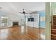 Bright living room with hardwood floors, fireplace, built-in shelves, and multiple windows at 2508 W Shell Point Rd, Tampa, FL 33611