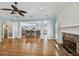 Open concept living area featuring a fireplace, hardwood floors and seamless connection to the kitchen at 2508 W Shell Point Rd, Tampa, FL 33611
