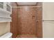 Tiled shower featuring shower head, towel rack and built-in shower niche at 2508 W Shell Point Rd, Tampa, FL 33611