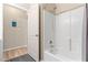 Clean bathroom with tub and shower combination and white tile surround at 2717 Via Cipriani # 620A, Clearwater, FL 33764
