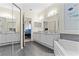 Spacious bathroom with double vanity, soaking tub, and decorative mirrors at 2717 Via Cipriani # 620A, Clearwater, FL 33764