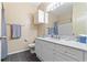 Bathroom featuring double sinks, white cabinets, and modern fixtures at 2717 Via Cipriani # 620A, Clearwater, FL 33764
