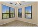 Bright bedroom features three large windows with outside views and light wood laminate flooring at 2717 Via Cipriani # 620A, Clearwater, FL 33764