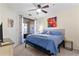 Comfortable bedroom with ceiling fan and sliding glass doors to balcony at 2717 Via Cipriani # 620A, Clearwater, FL 33764